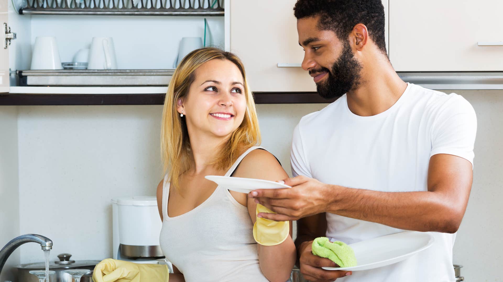 woman smiling doing chores to help husband