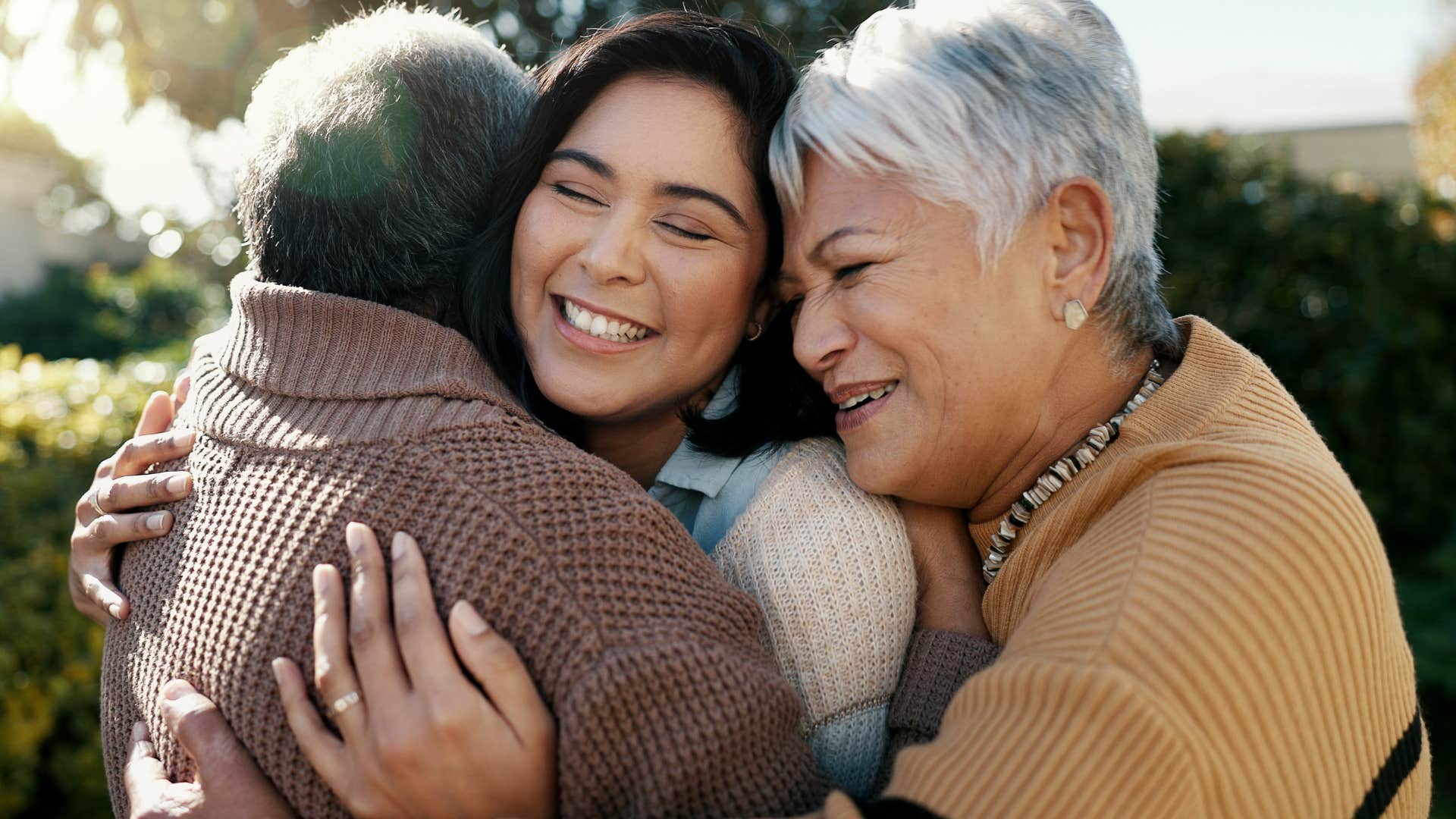 woman hugging her parents at a family reunion