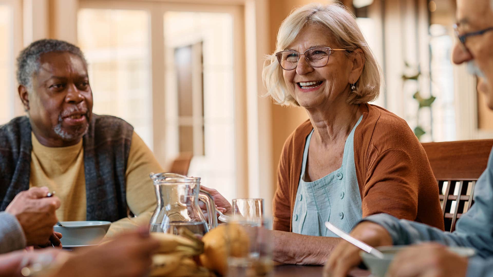 woman smiling at a group dinner with friends