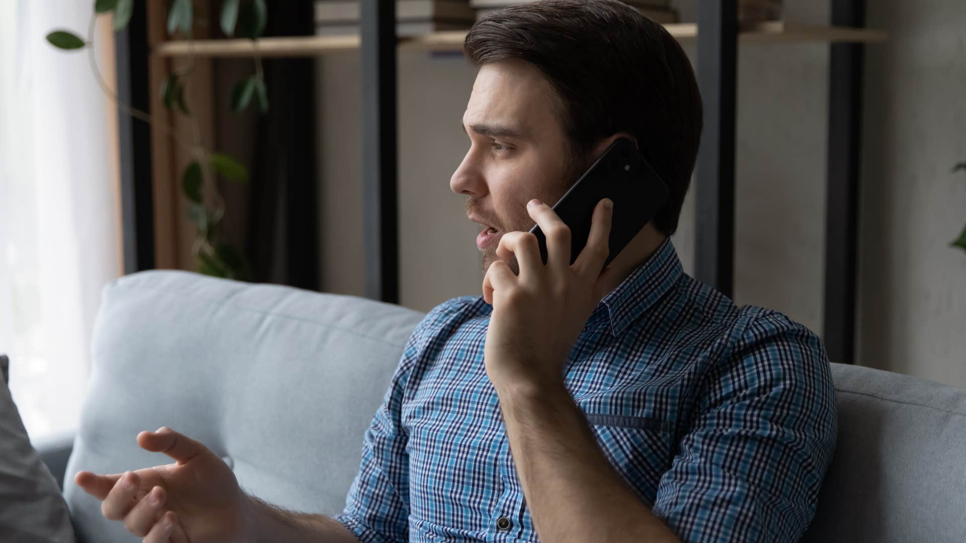 man saying no to last-minute plans on his phone
