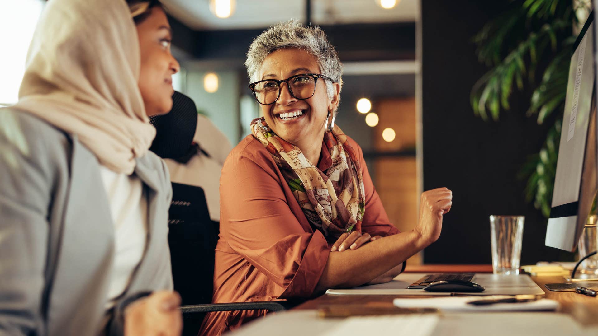 woman working in-person talking to colleague