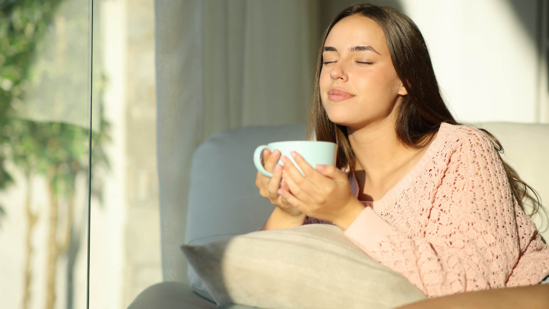 energetically sensitive woman at home drinking tea in the sun