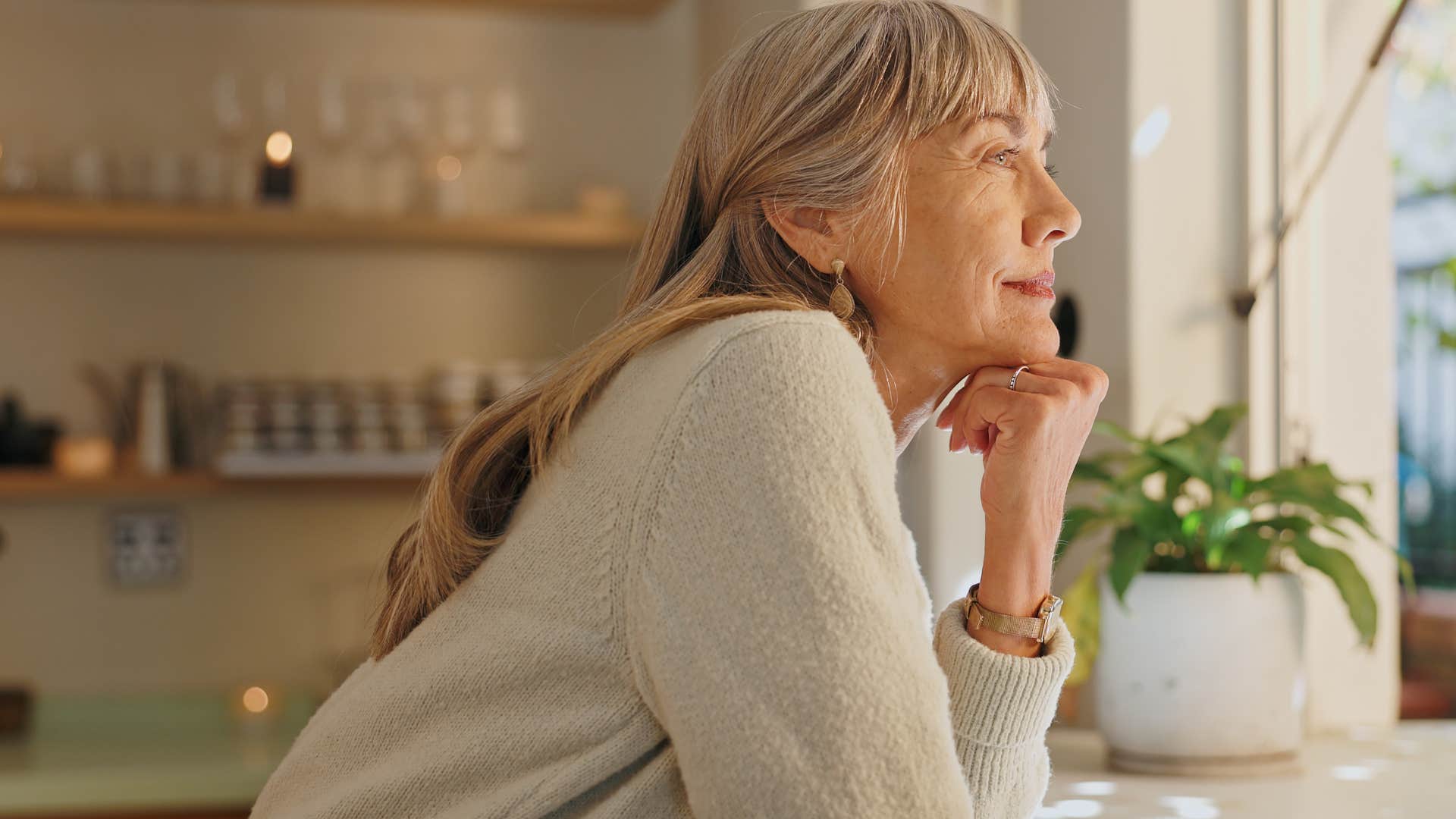 woman who's a homebody smiling in her kitchen