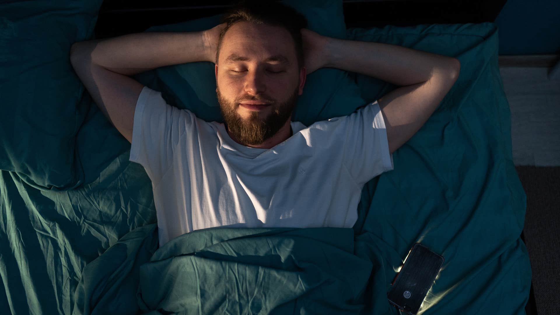 Man who's attuned to his body's needs lying in bed.