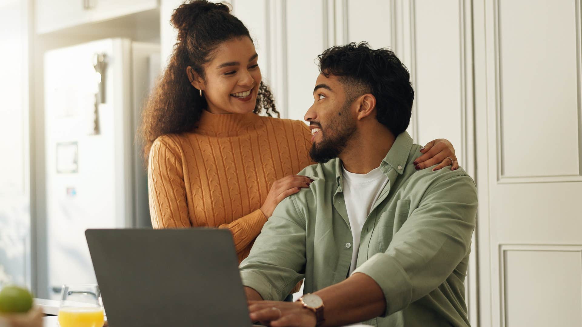 observant man talking to his partner at home