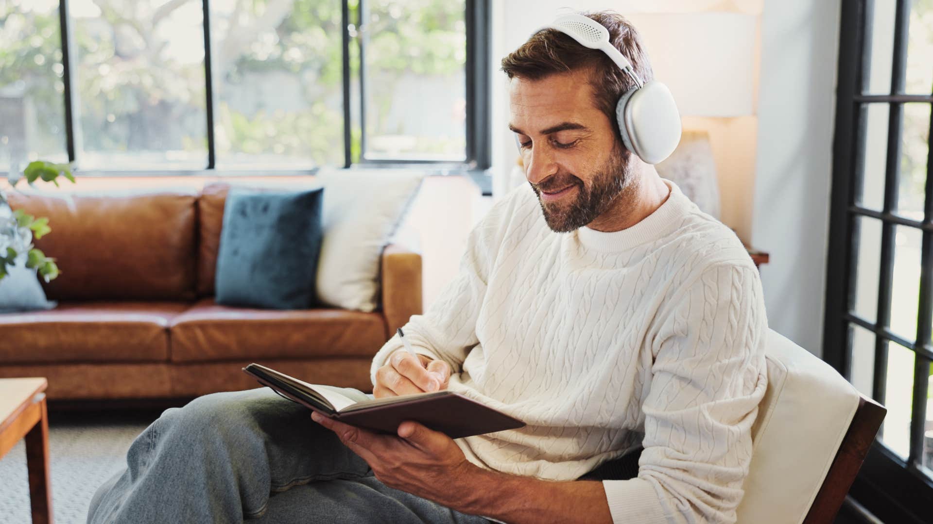 wildly creative man writing at home