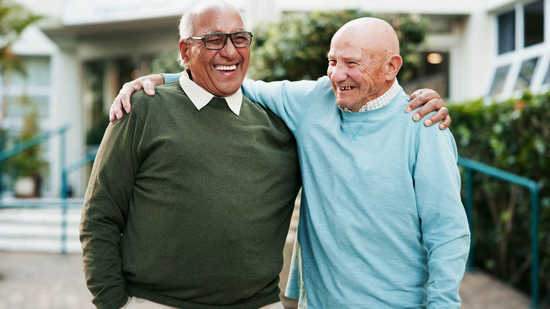 man being protective over his friend hugging