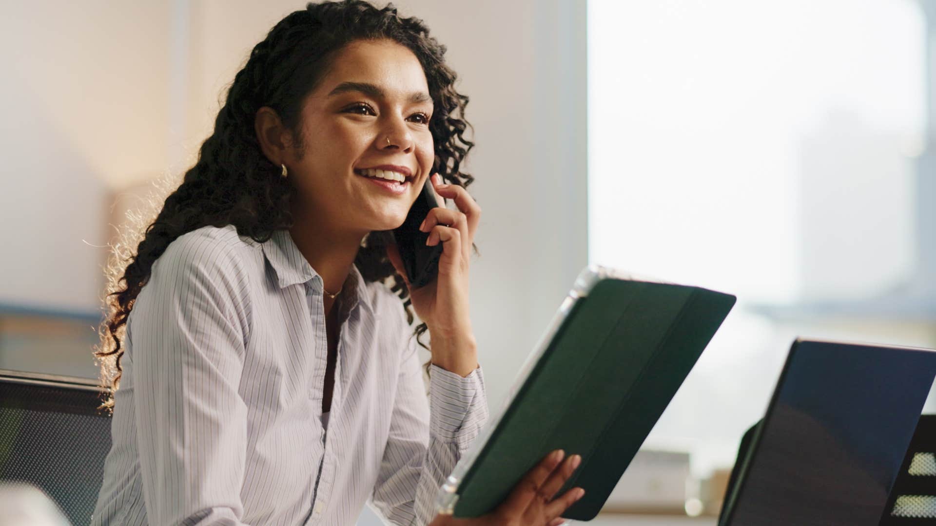 socially aware and intuitive woman smiling at work