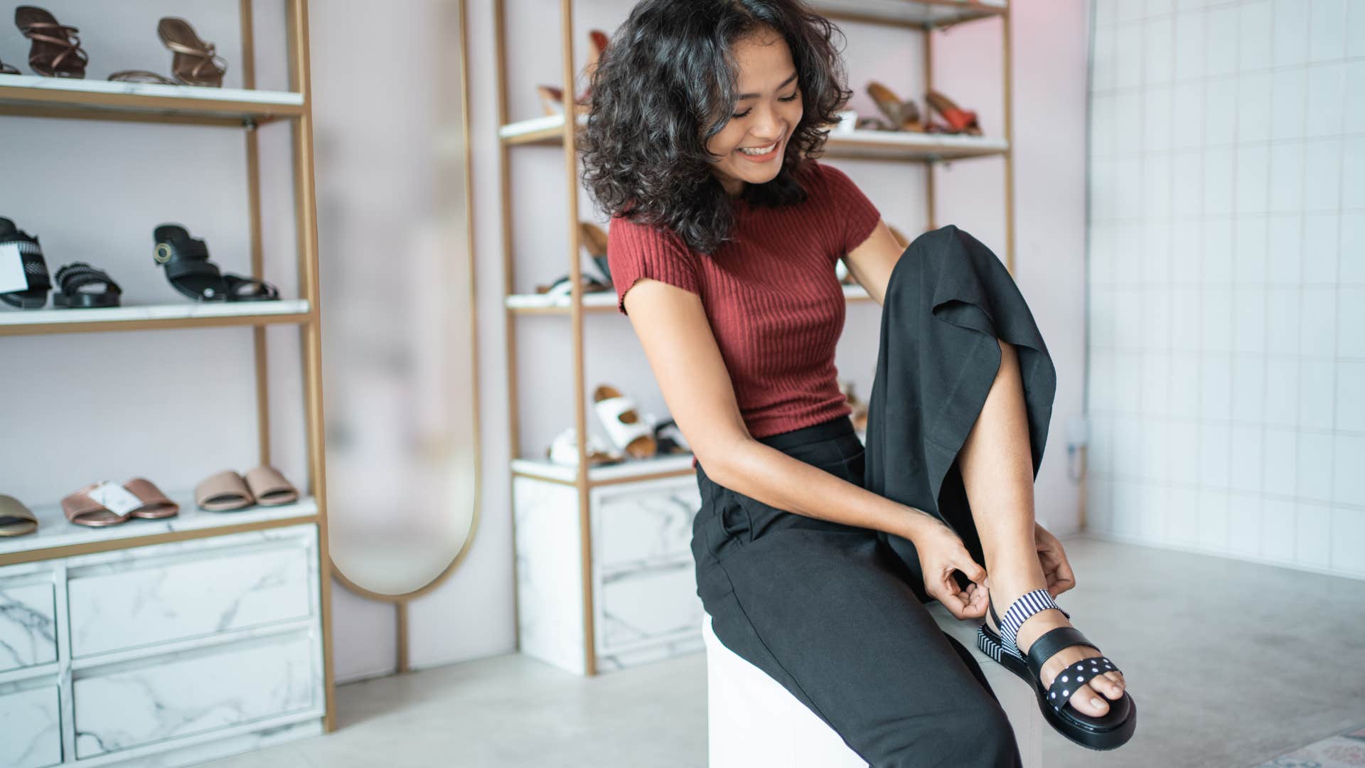 if you grew up broke but made it, you still probably can't bring yourself to buy these simple things new shoes just for fun woman trying on shoes