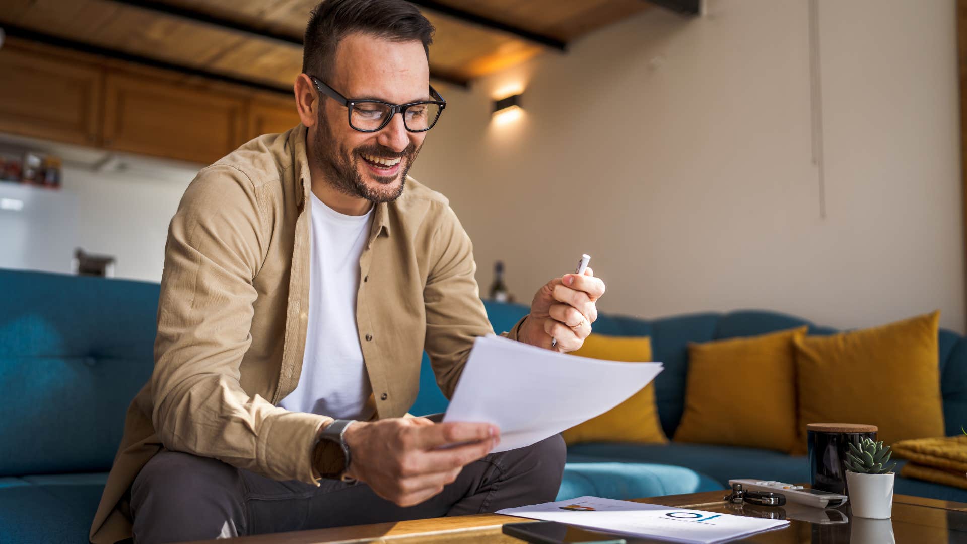if you grew up poor, you probably have these habits that make you way better than normal people making something out of nothing man looking at papers while working at home