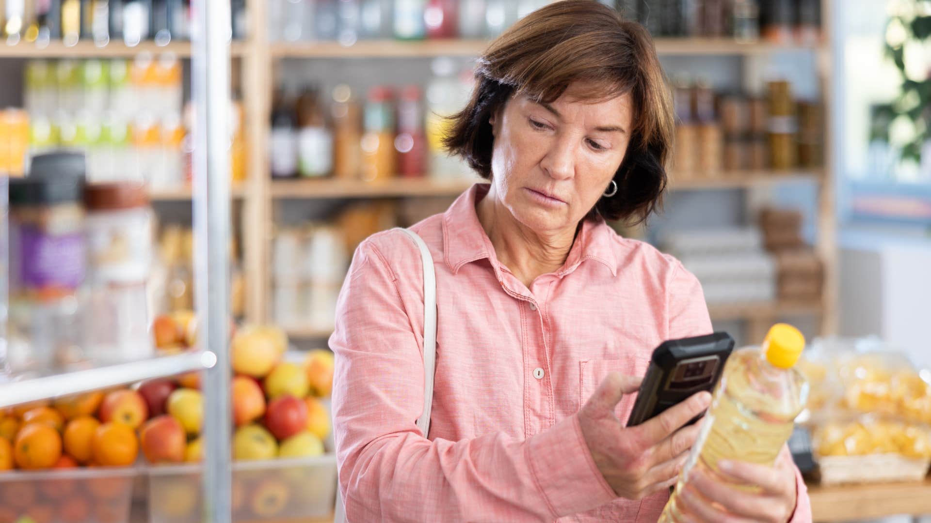 Woman who never shops hungry in the grocery store.