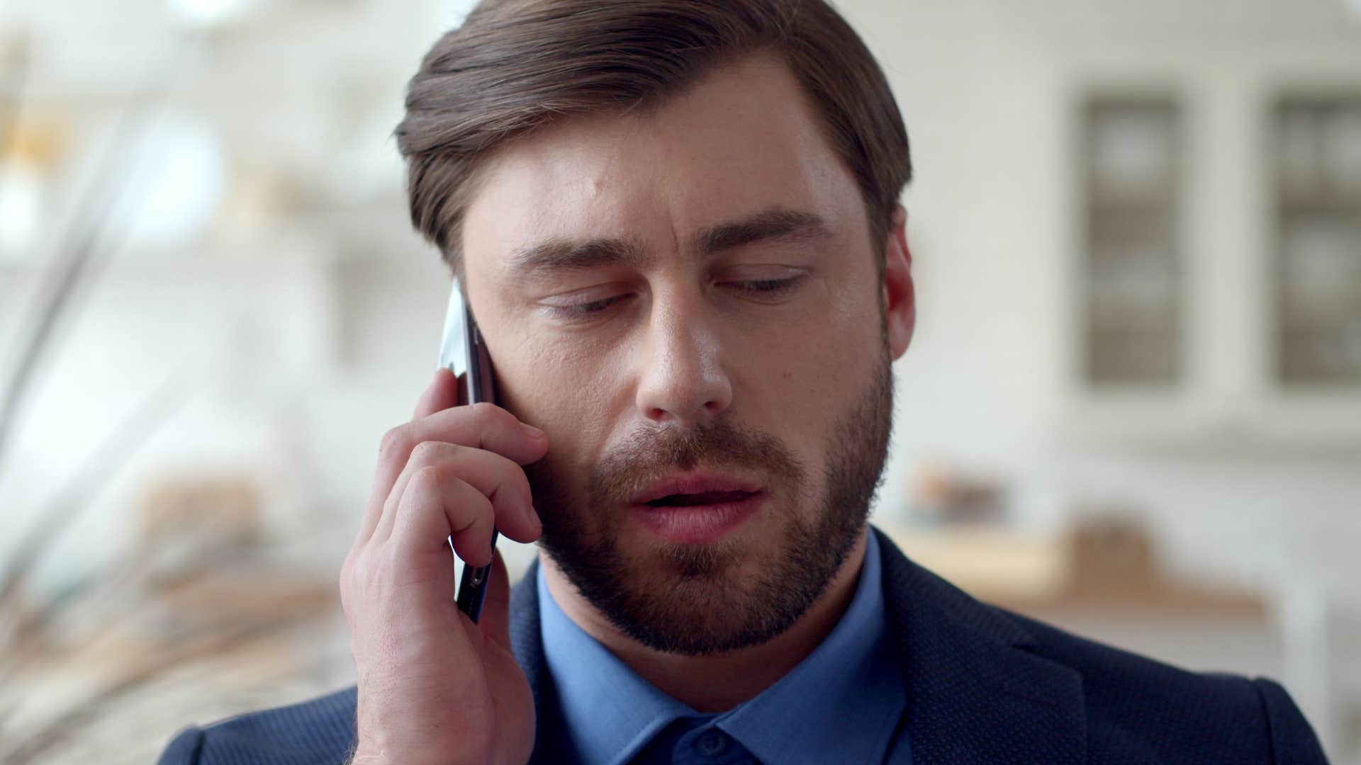 man with phone anxiety looking stressed talking on phone