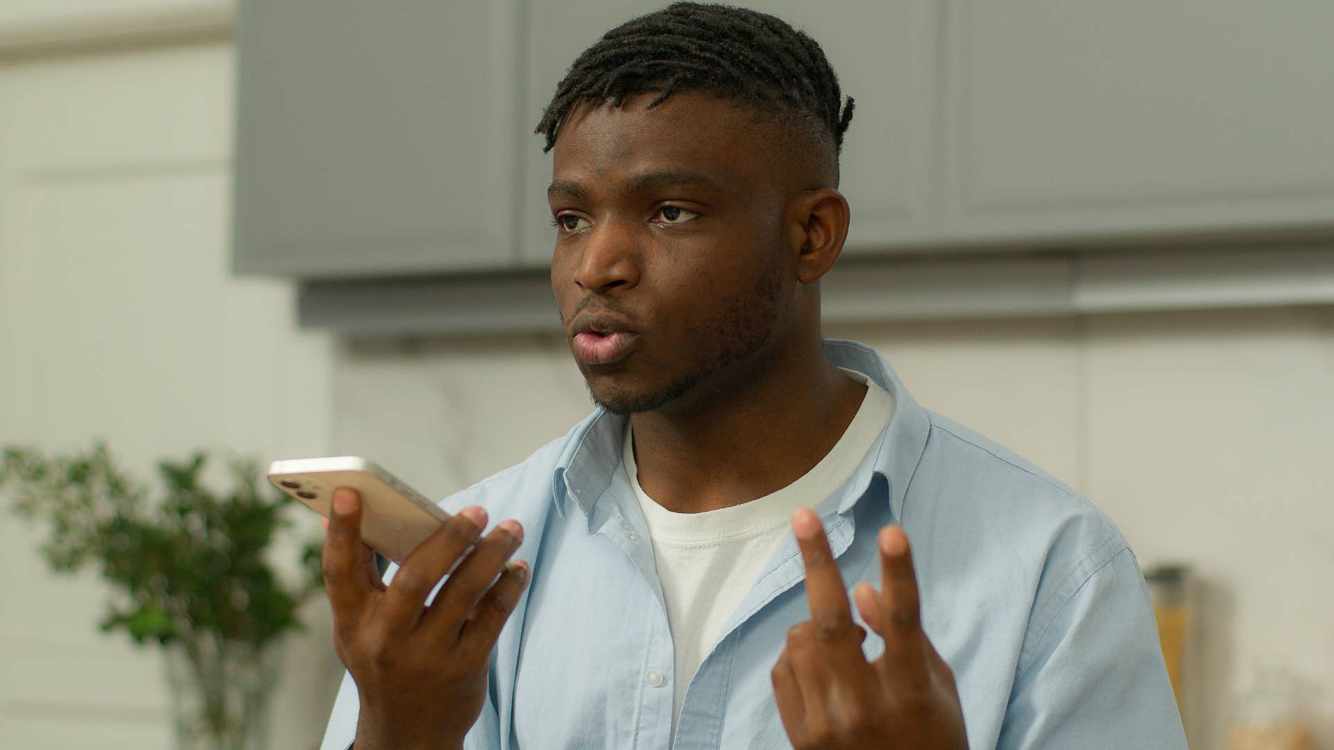 Man who's being okay with disappointing people on the phone.