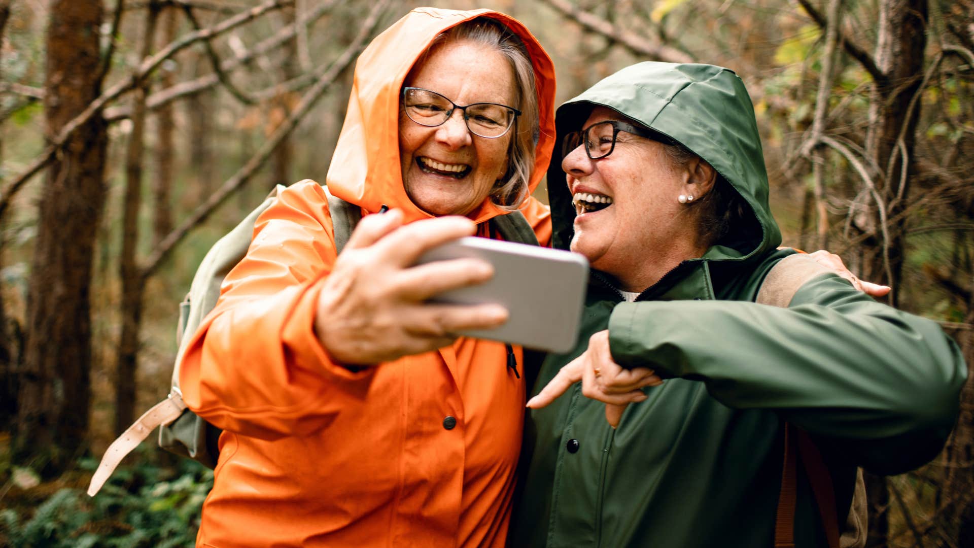 Friends embracing the weirdness in the rain outside.