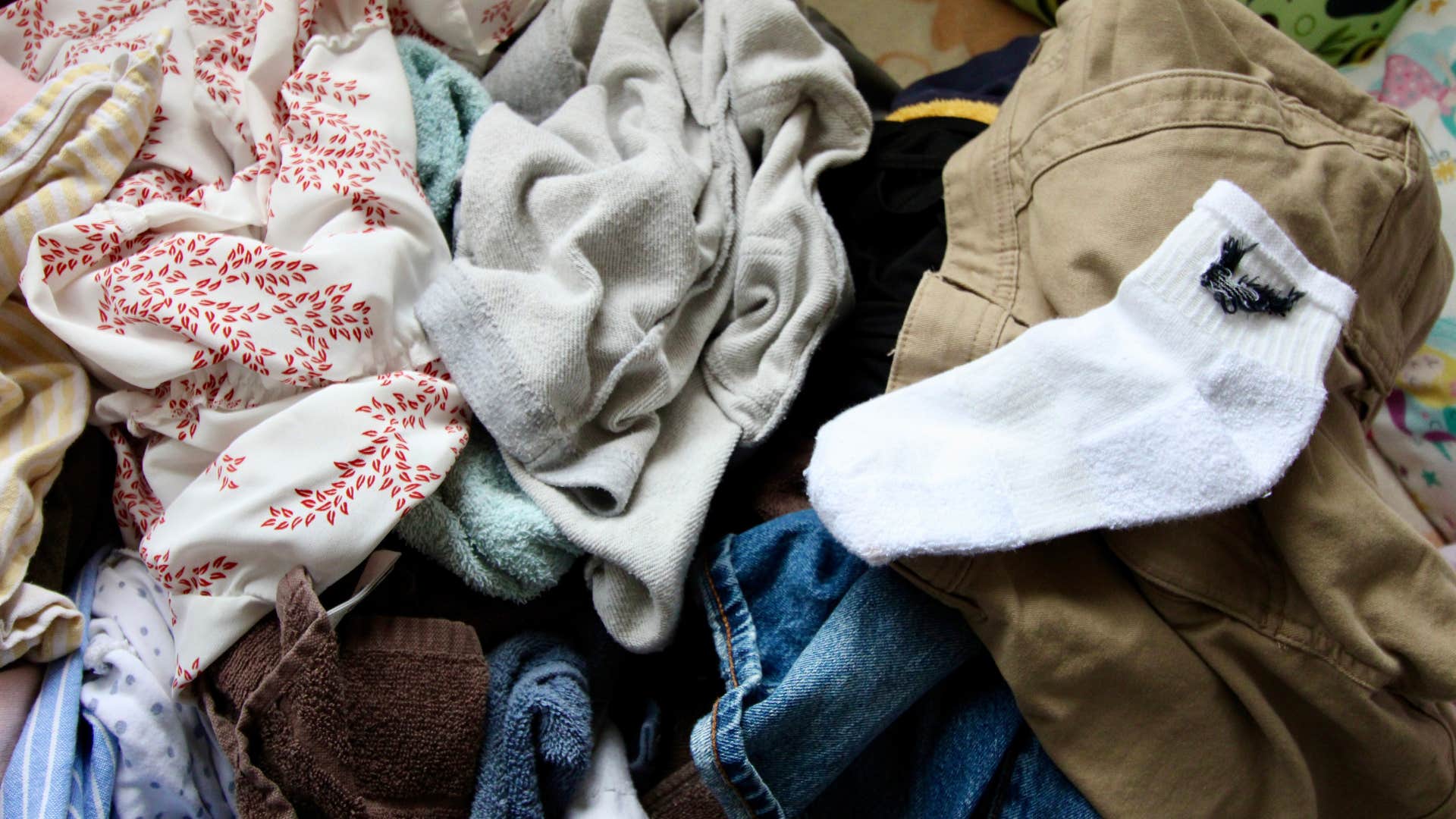 if you notice these things in someone’s house they’re probably going through a hard time pile of clean laundry that never gets put away