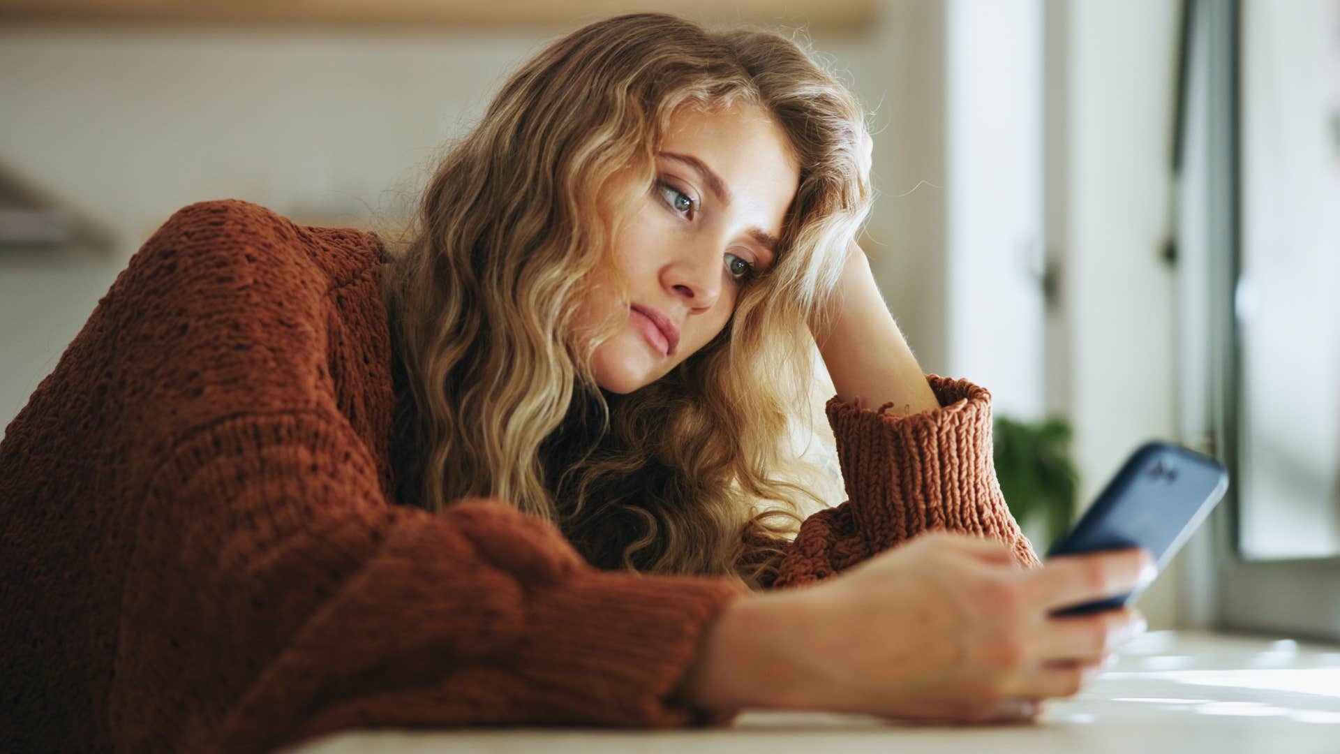 Woman who feels behind in life on her phone