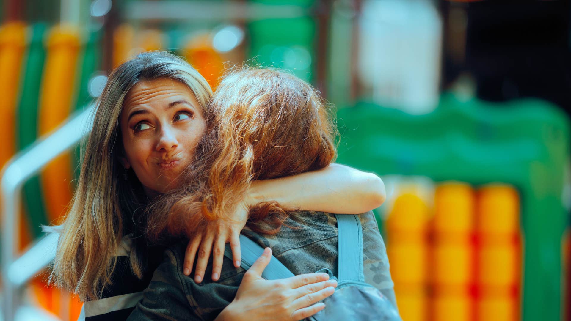 woman hugging friend fakely as she says you're doing the best that you can with what you have