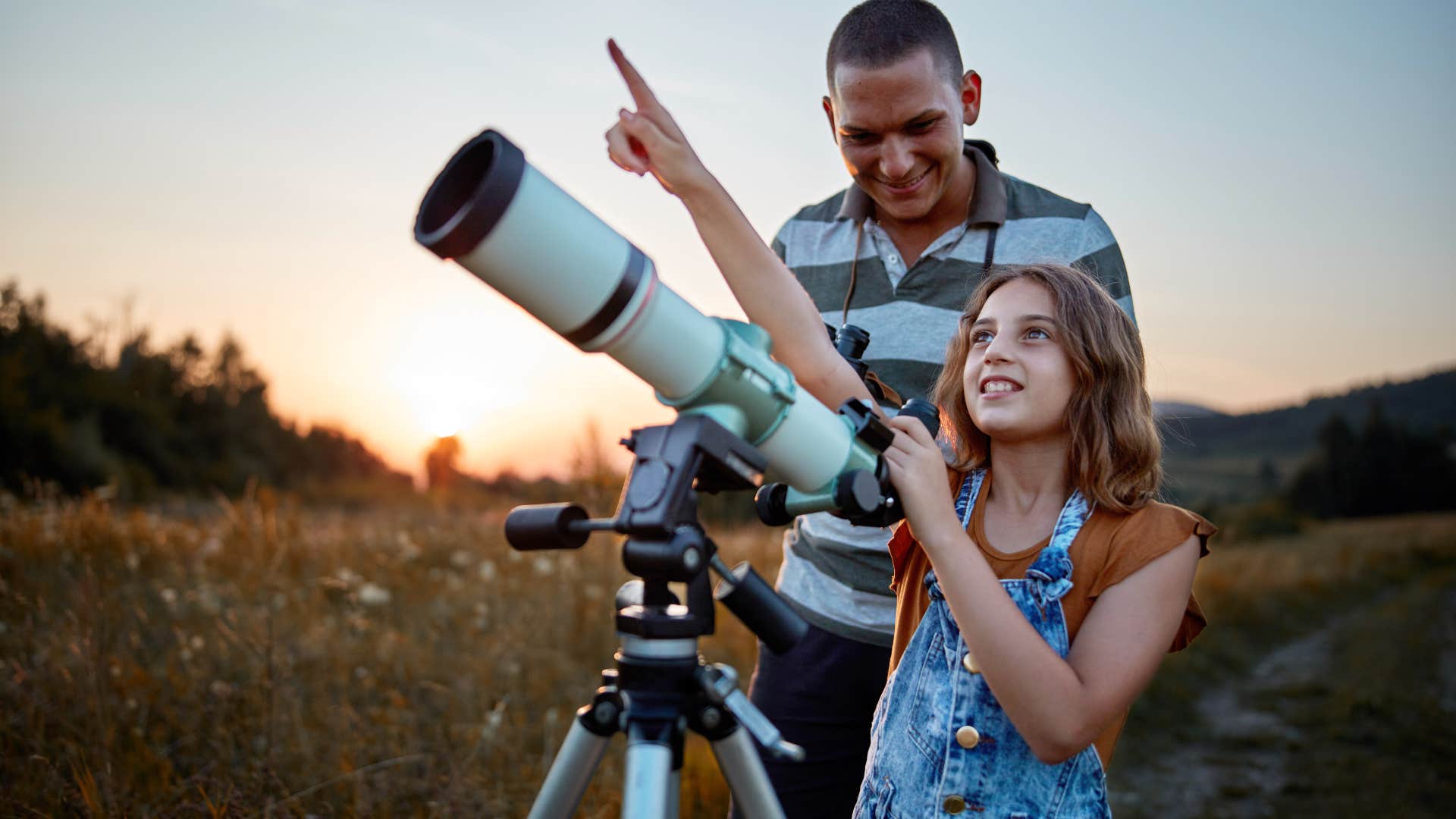 lessons the most successful kids learn from their parents intellectual curiosity curious young girl looking through telescope with dad