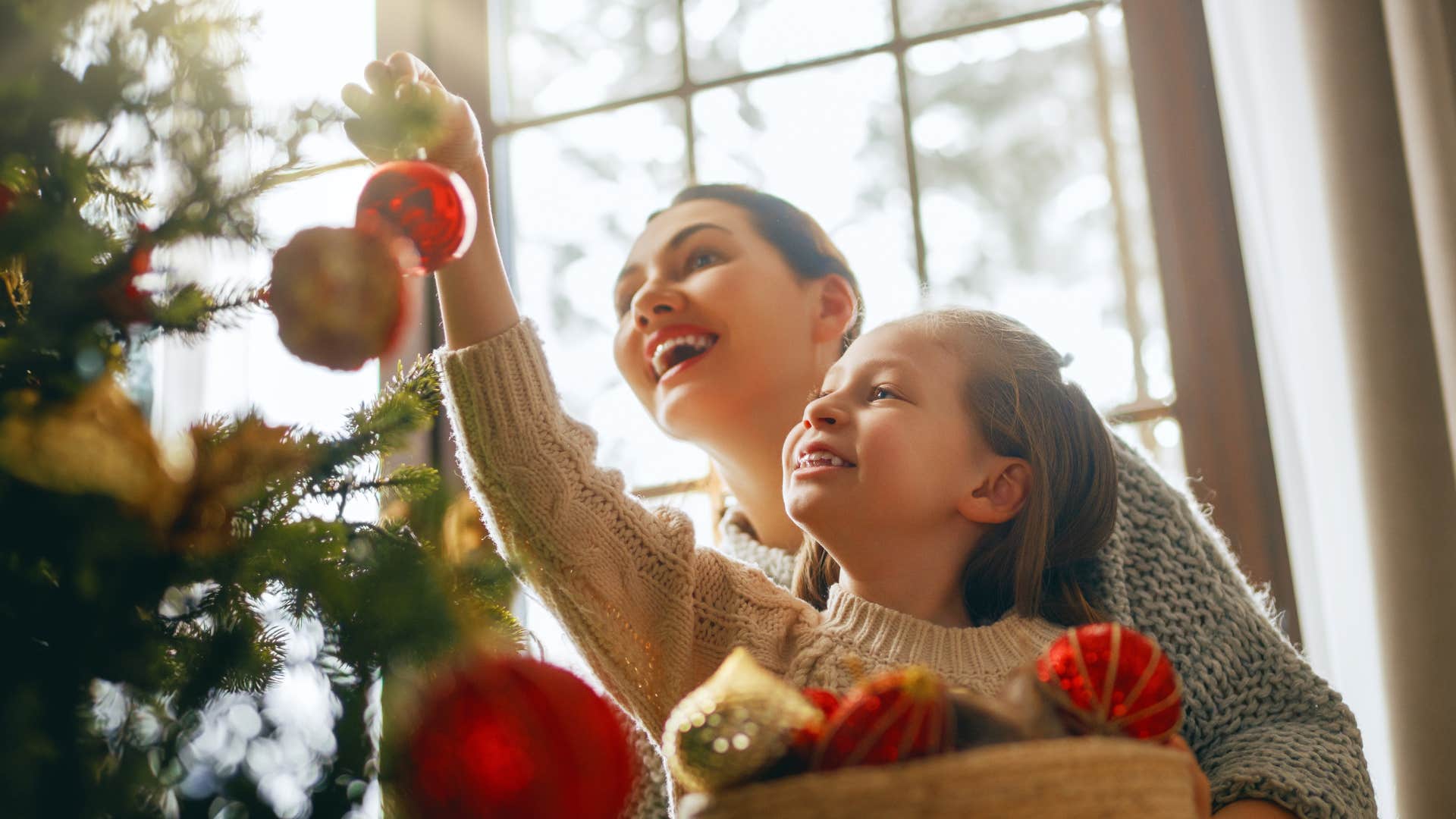 lessons the most successful kids learn from their parents tradition mom and daughter celebrating tradition decorating christmas tree