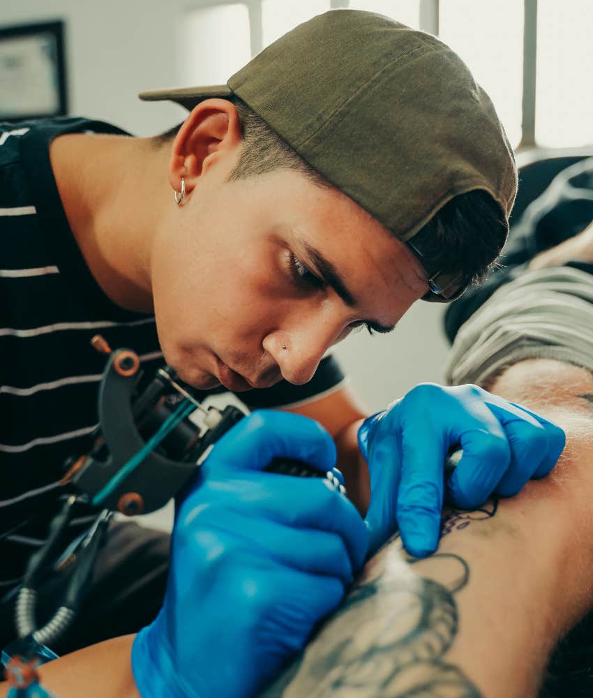 man getting tattoo done tipping