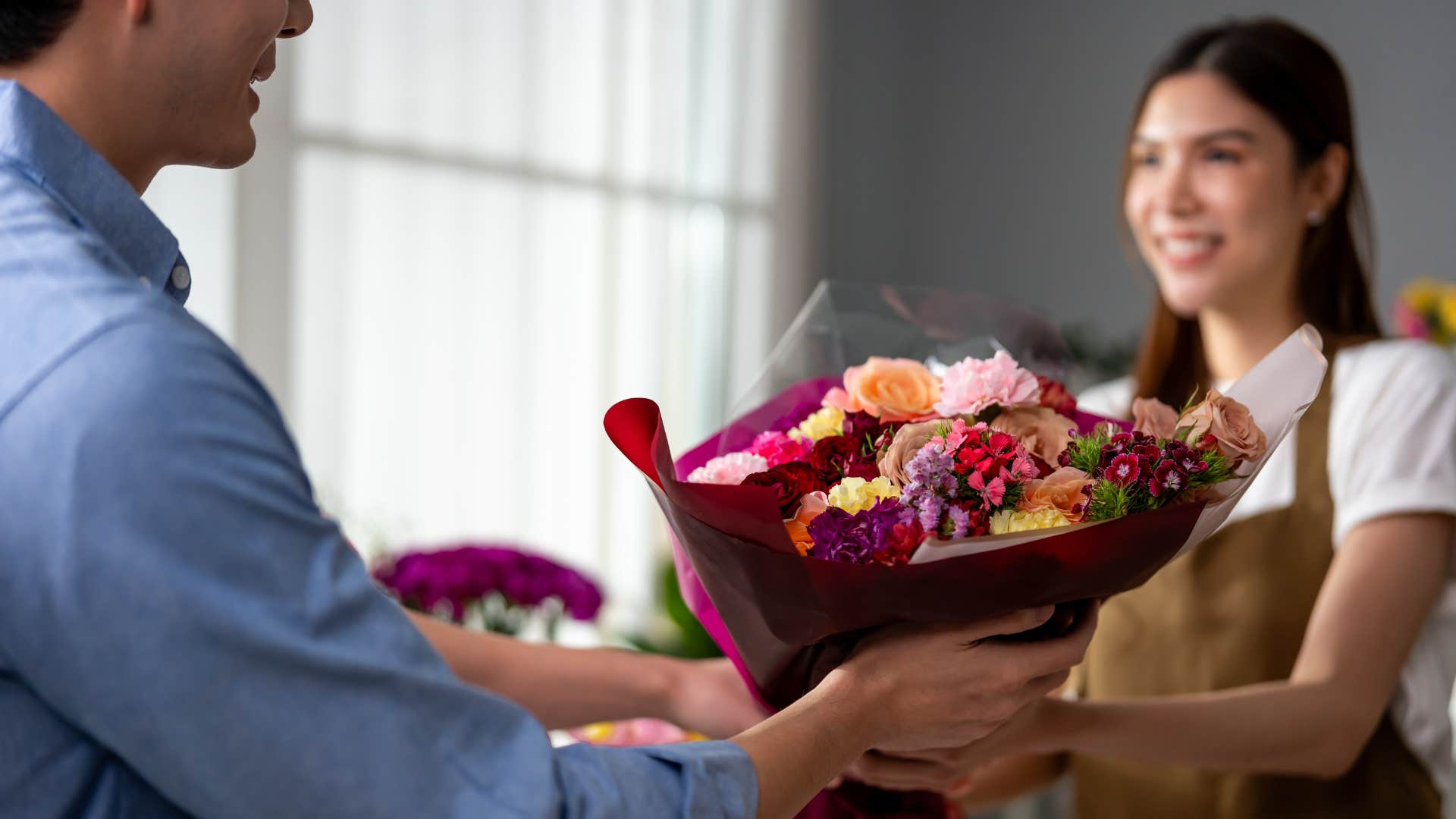 man in blue buying woman flowers as he remembers small details about her
