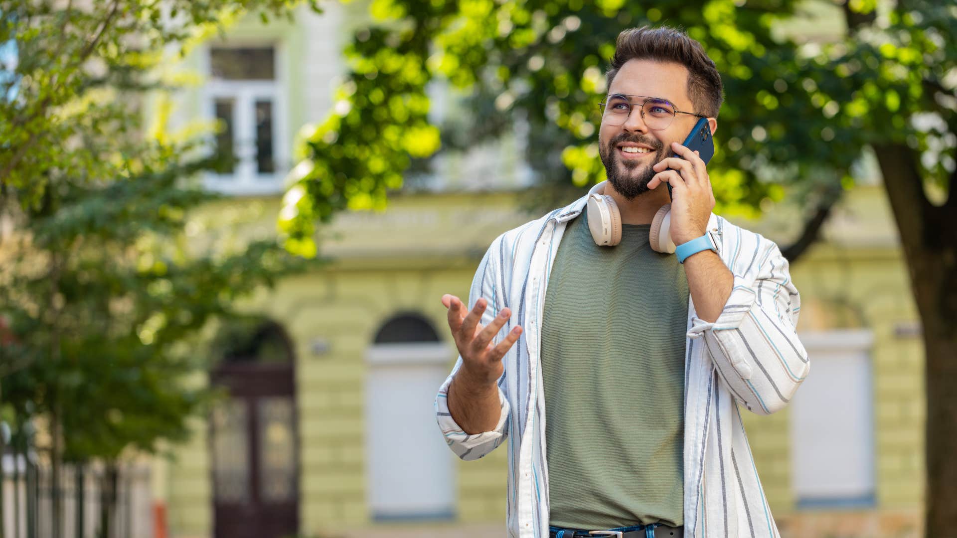 man in green shirt talks about woman to his friends and family as he smiles brightly