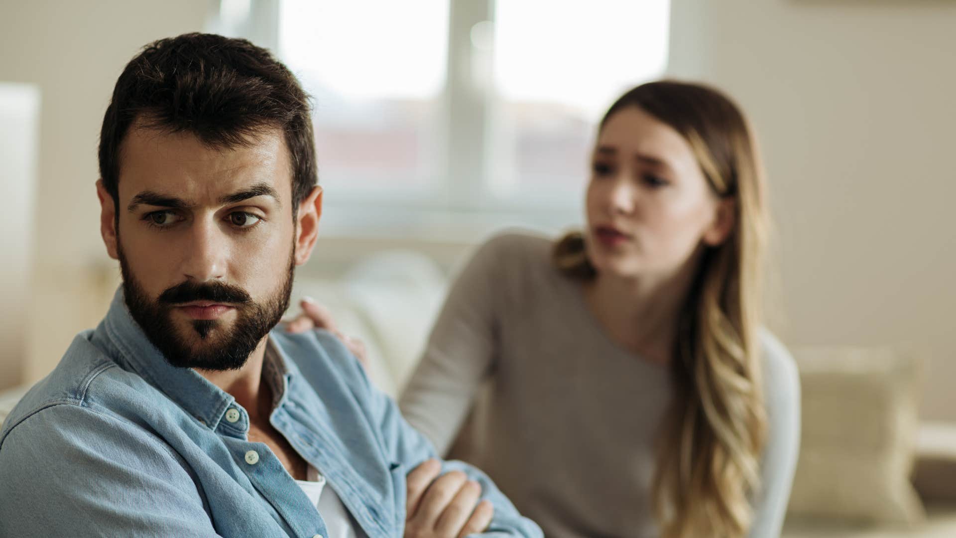 man suppressing his anger ignoring his partner