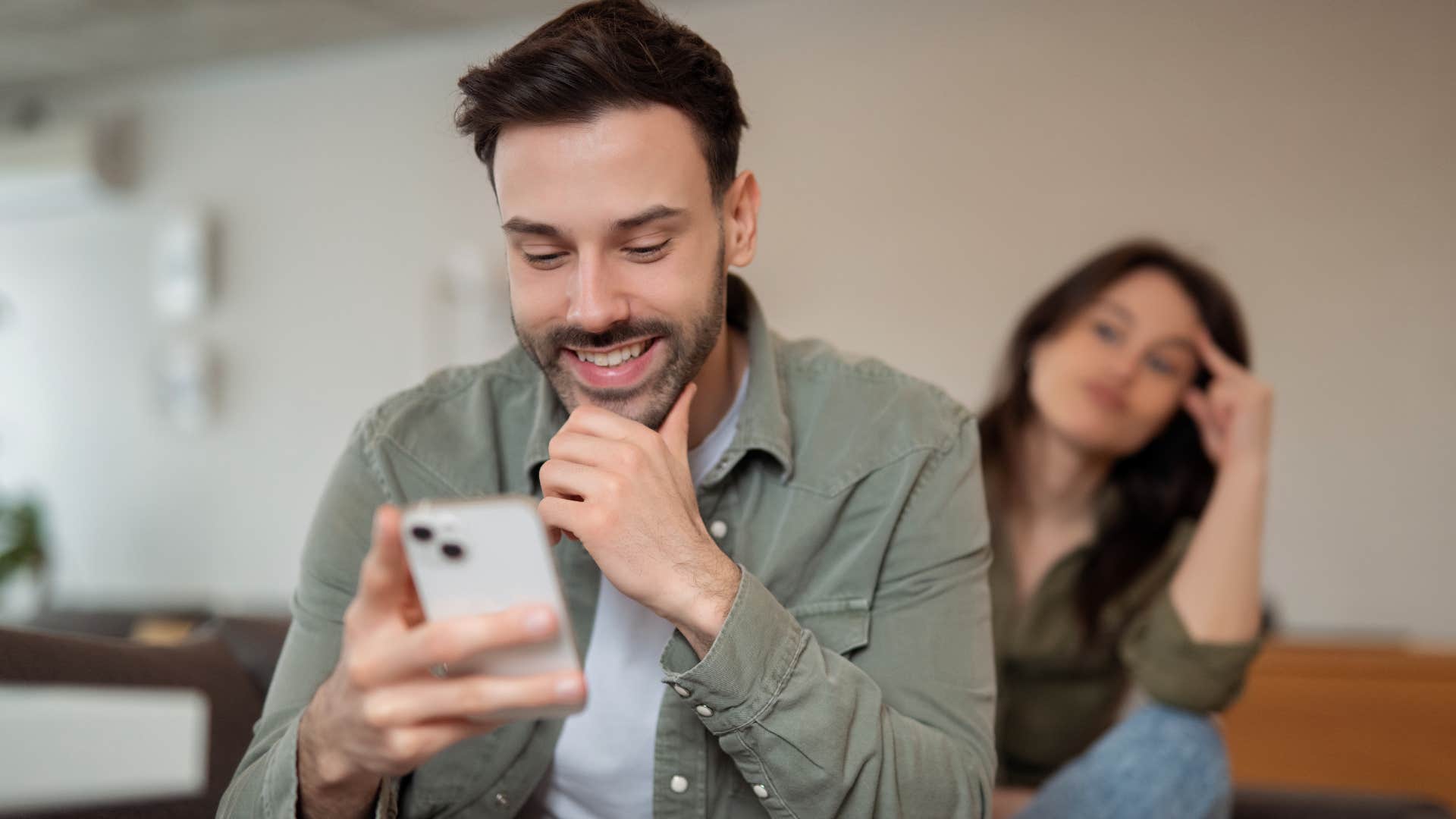 lean into distractions men who are quietly falling out of love with their wives usually do these things around the house Man leaning into distractions with his phone at home.