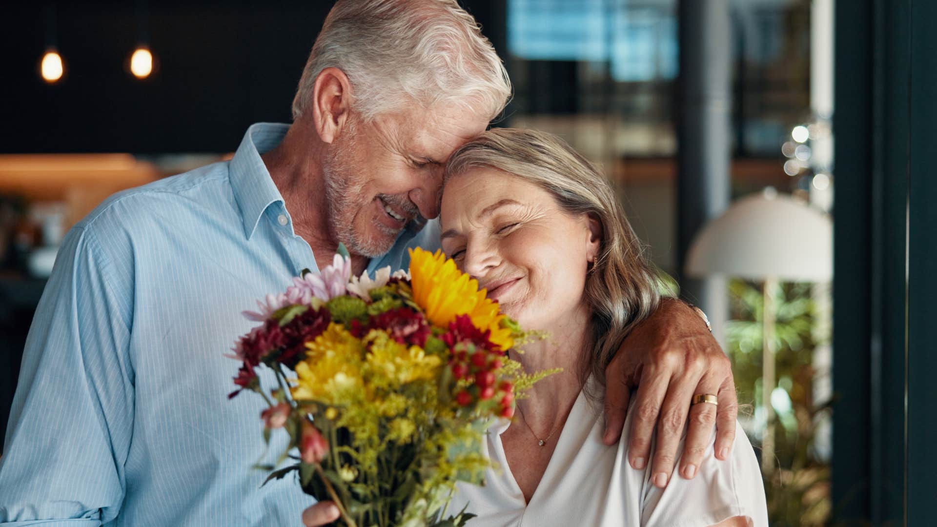 man apologizing to his wife with flowers