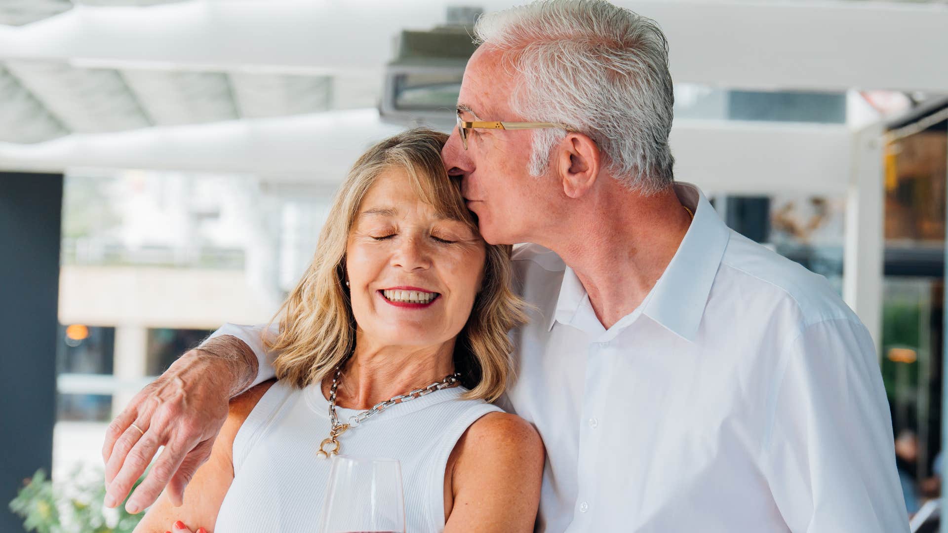 man checking in with his wife kissing her head