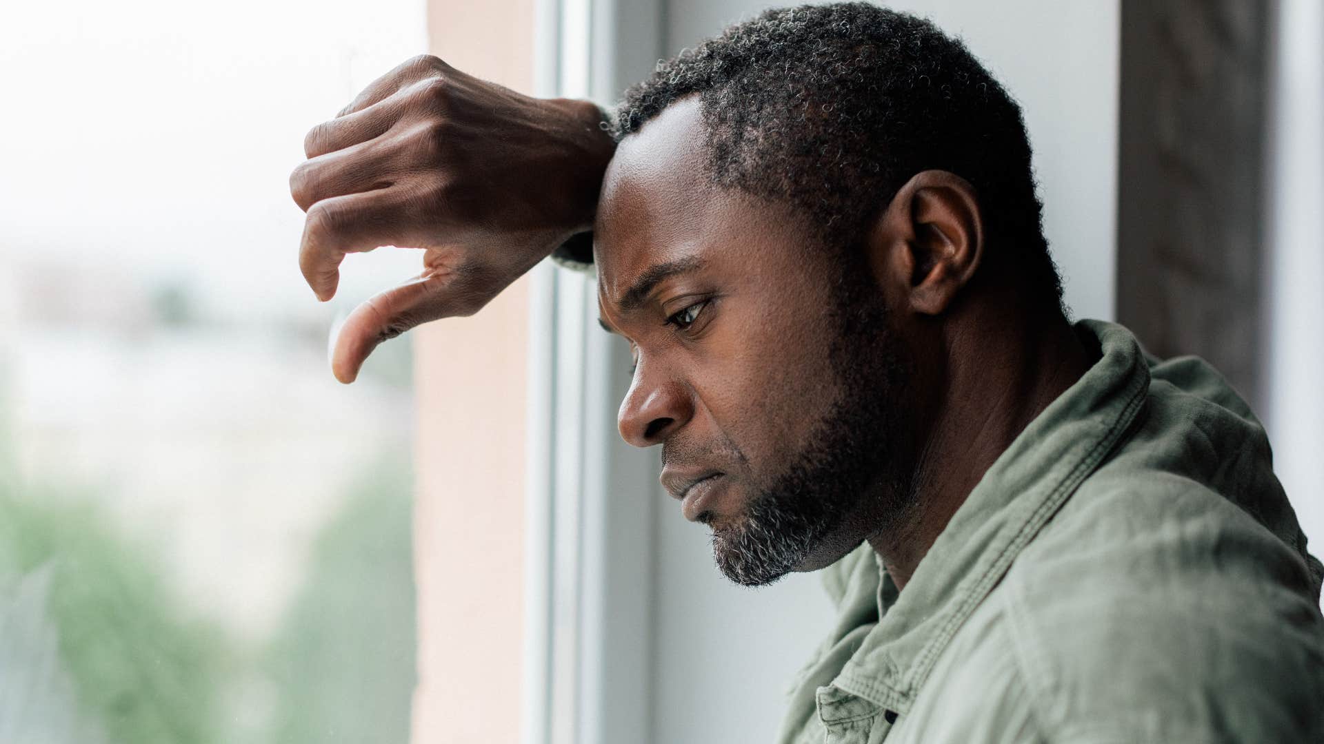 Man who struggles with commitment looking out a window.