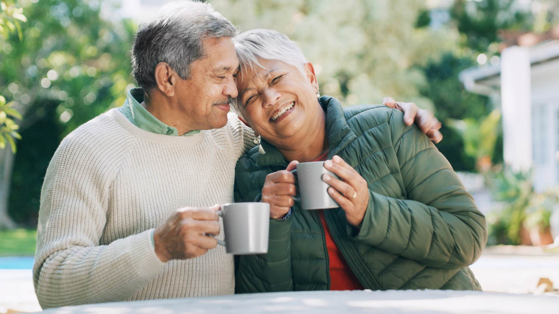 put away their phone when speaking men who still adore their wives after years always do these ordinary things that mean everything man smiling happily leaning on wife