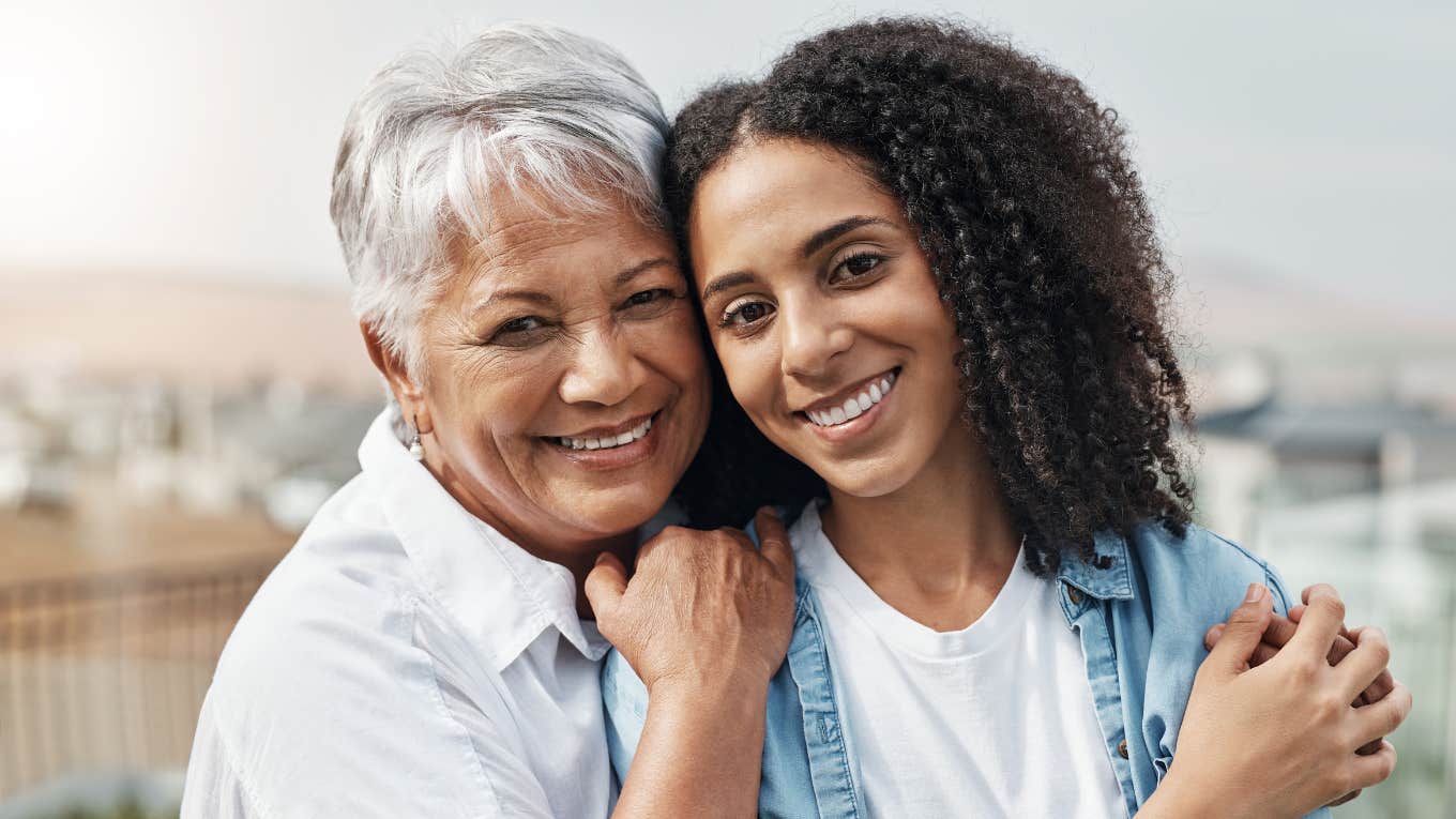 mom and daughter smiling hugging celebrating their bond