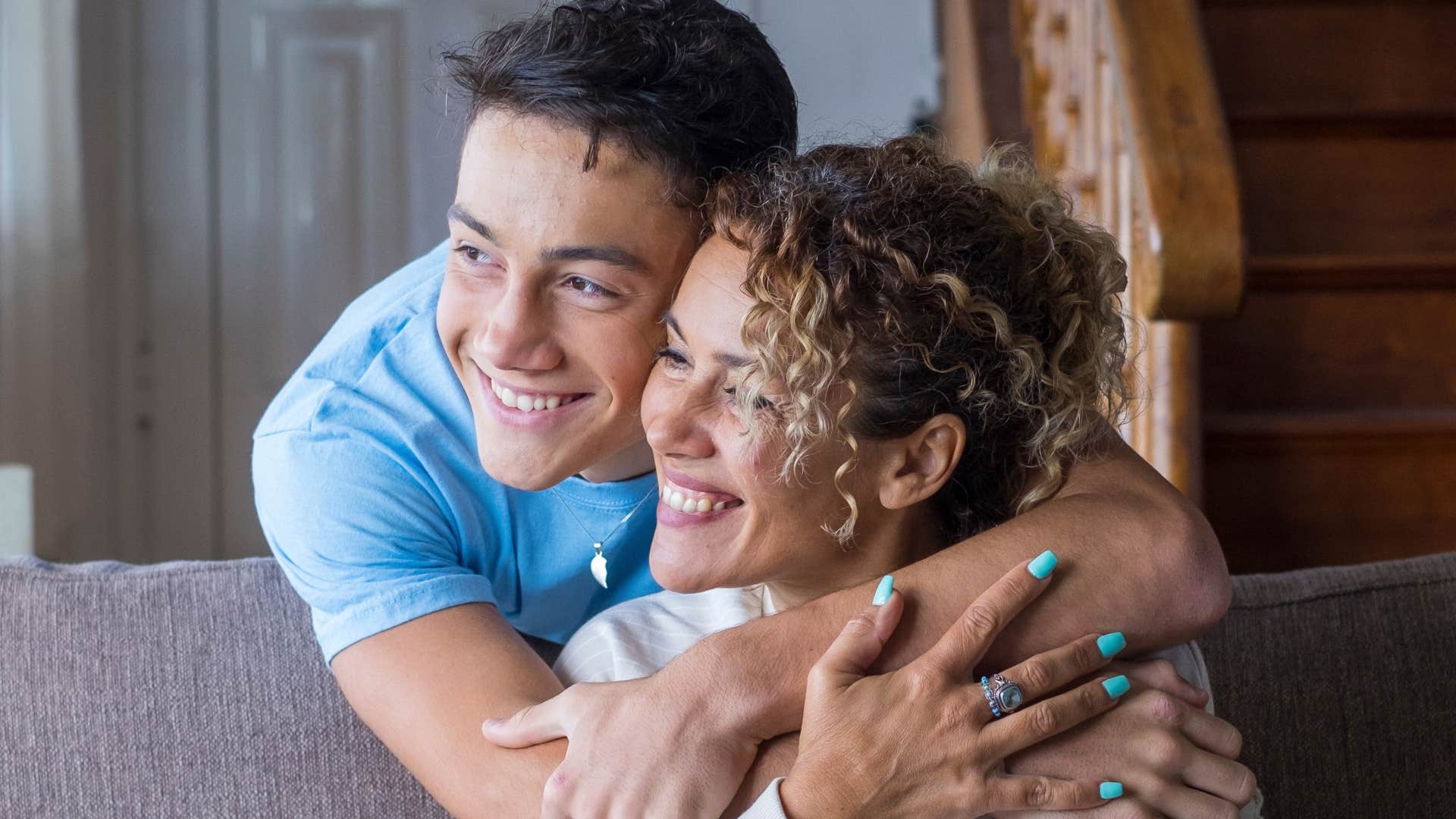 son and mom hugging smiling
