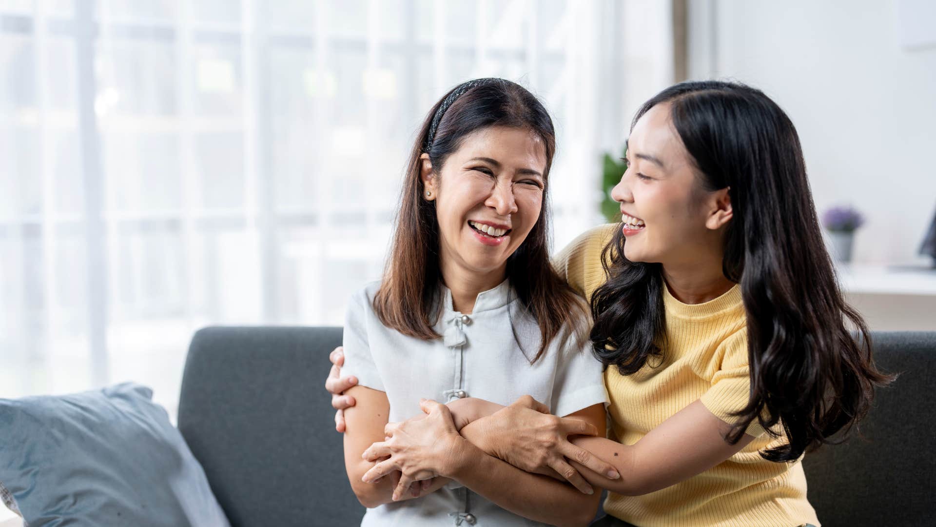 mom and daughter laughing together
