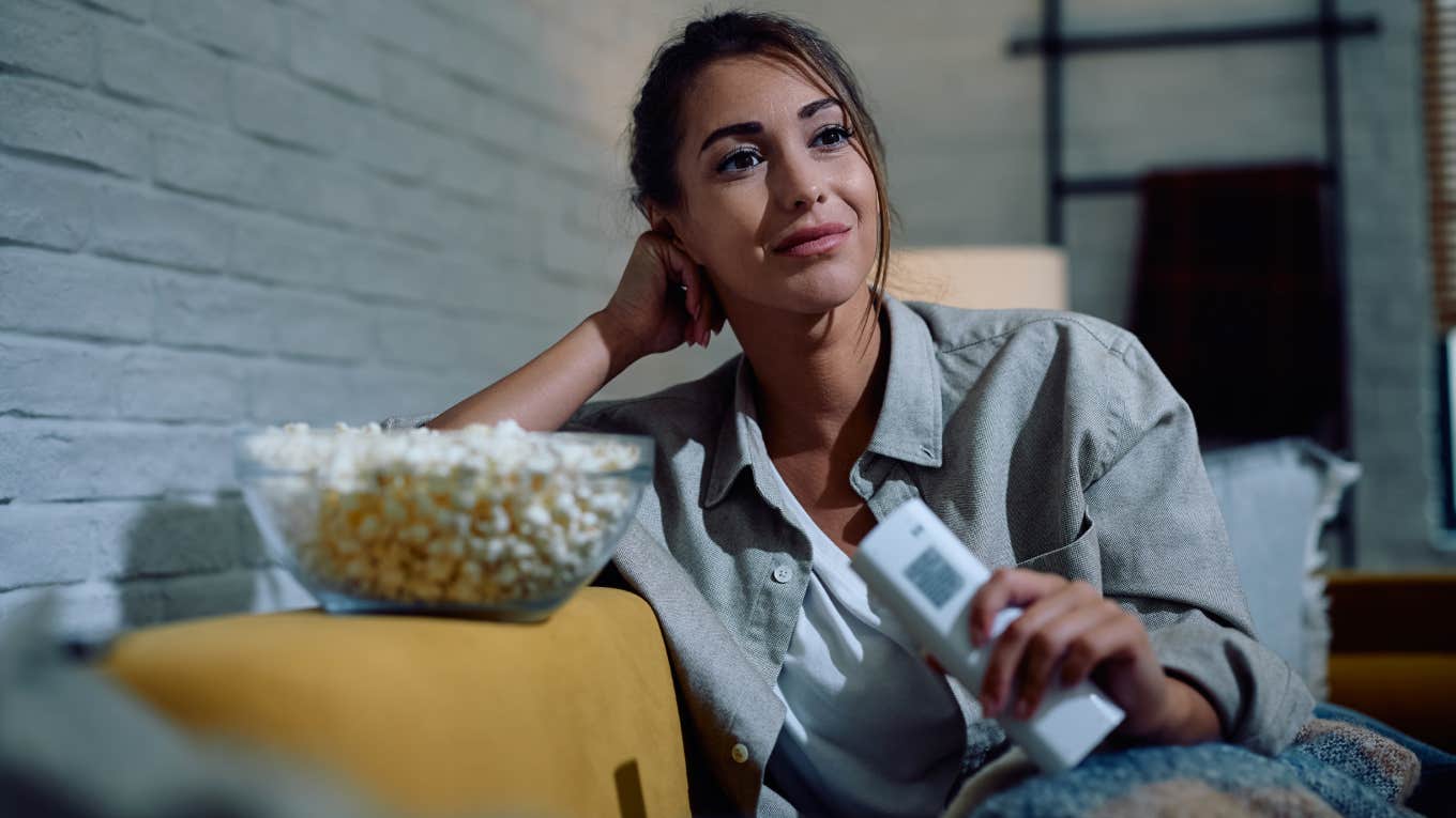 Mom Says Even The Worst ‘90s Movies Are Better Than Anything Released Today woman watching movie on couch with popcorn