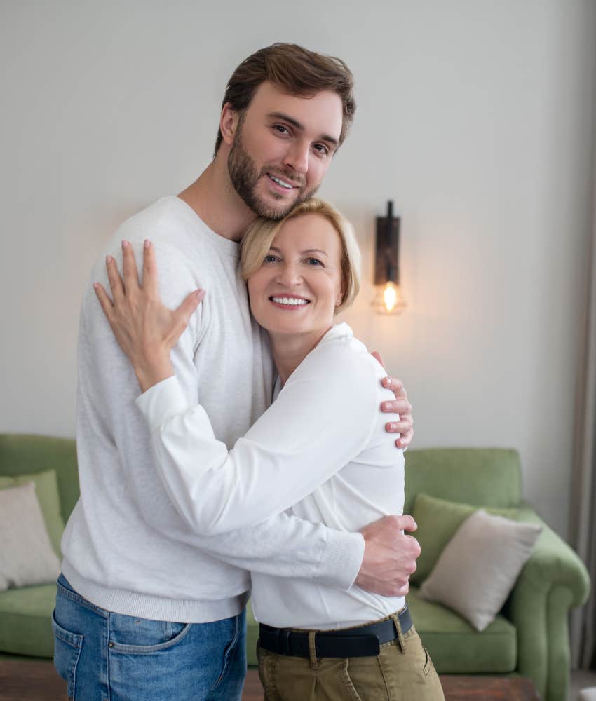 mom hugging adult son who she thinks needs a prenup before marrying fiancé