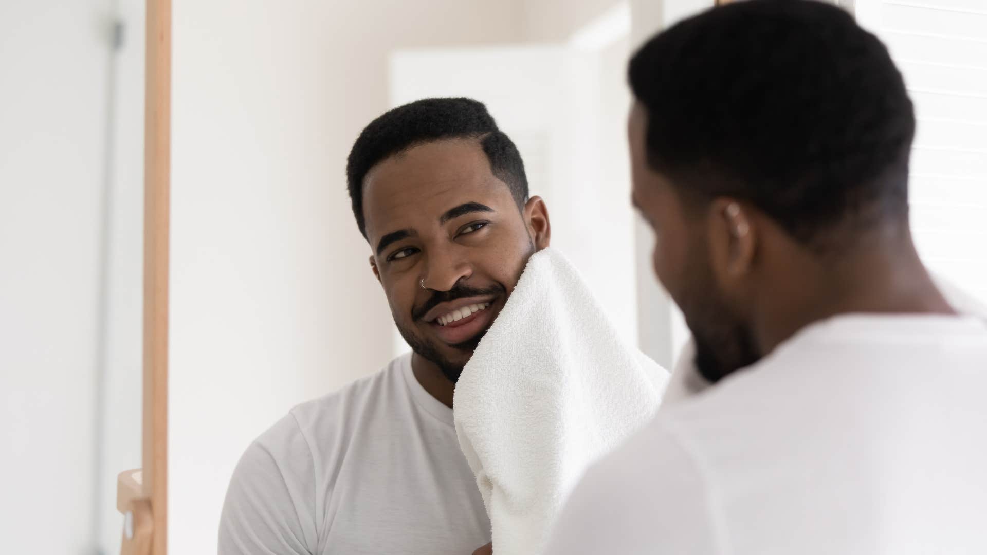 man cleaning face with overused towel