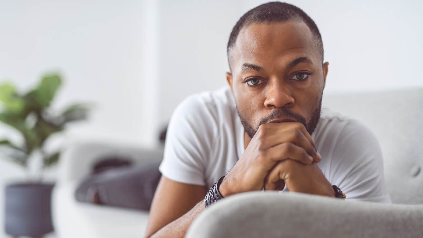 If You Notice These Little Things In A Man's House, He's Not Taking Very Good Care Of Himself sad man lounging on his couch neglecting his self-care