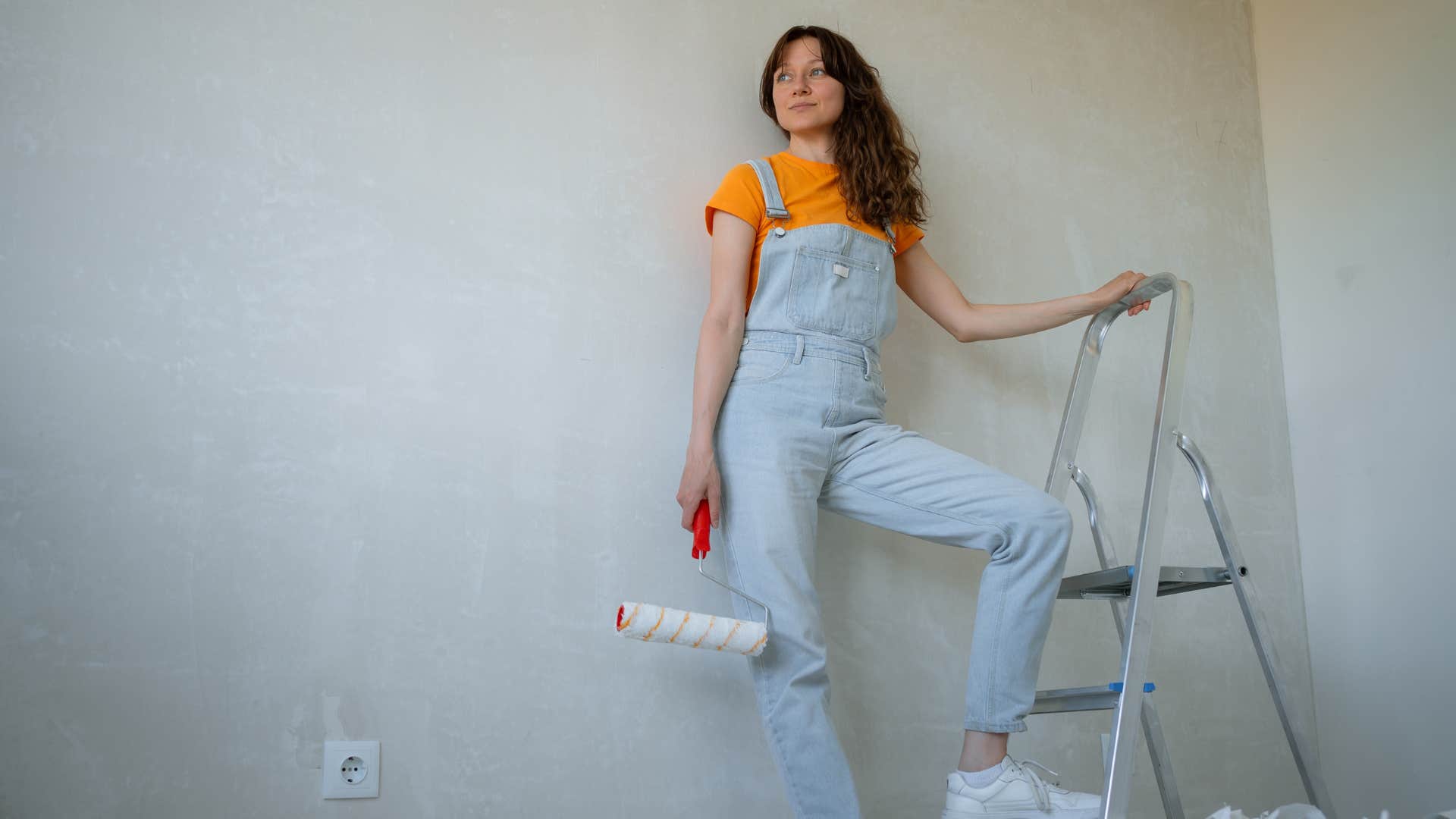 if you notice these things in someone's house they're likely in some sort of financial distress unfinished projects or broken appliances woman working on unfinished project painting her home