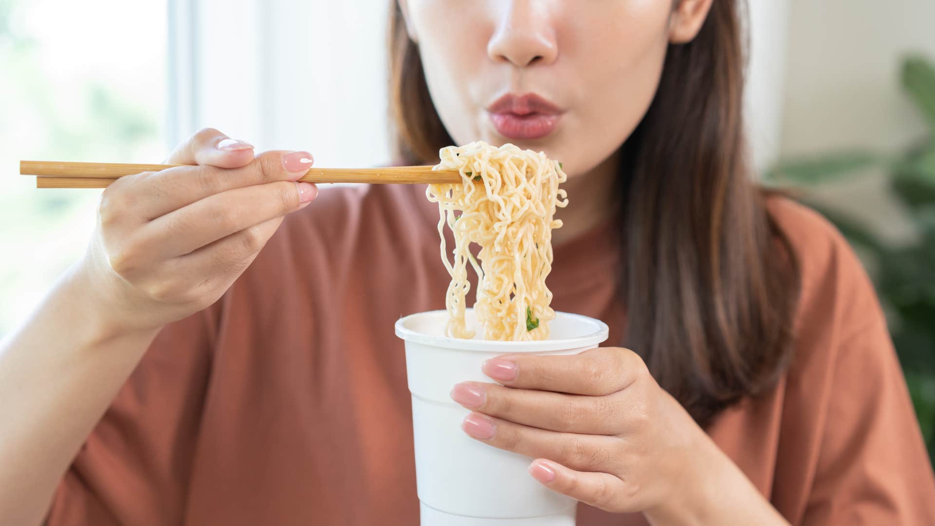 woman eating instant food ramen