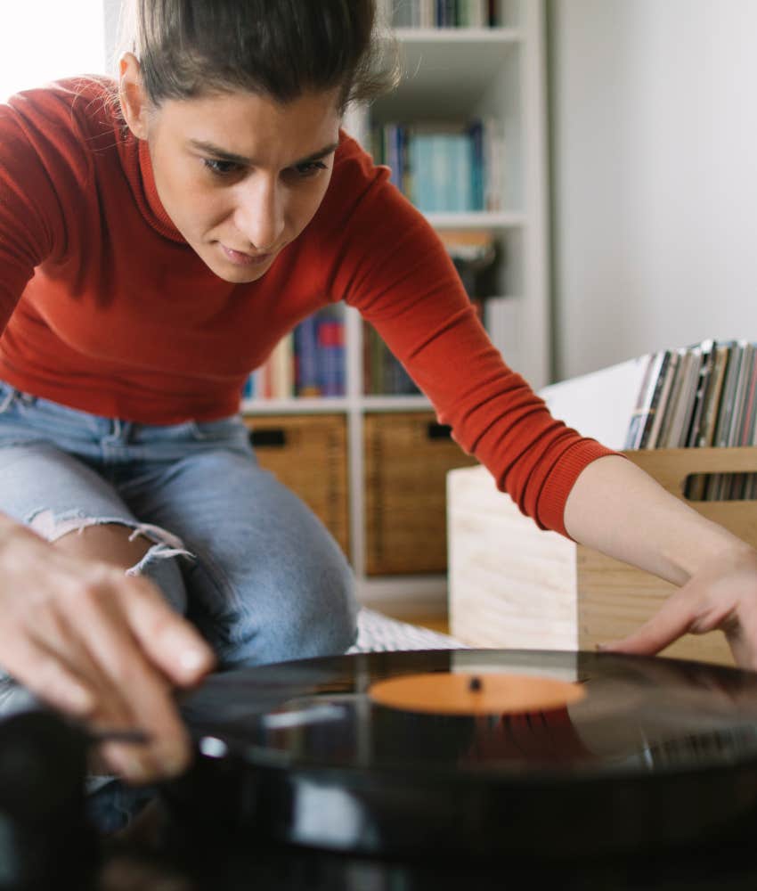 Old fashioned hobbies boomers grew up with that are trendy again audio Younger person places audio disc on player as new hobby