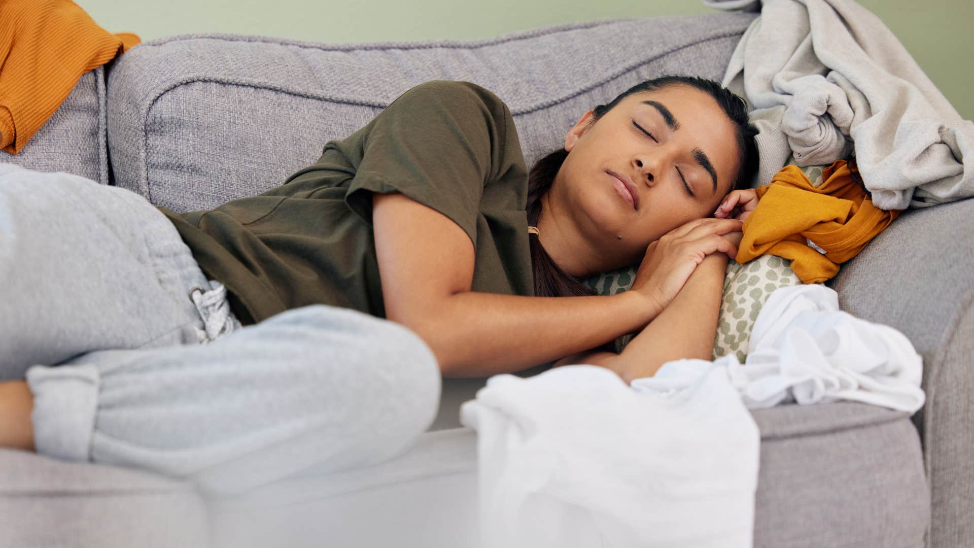 woman sleeping on clutter at home