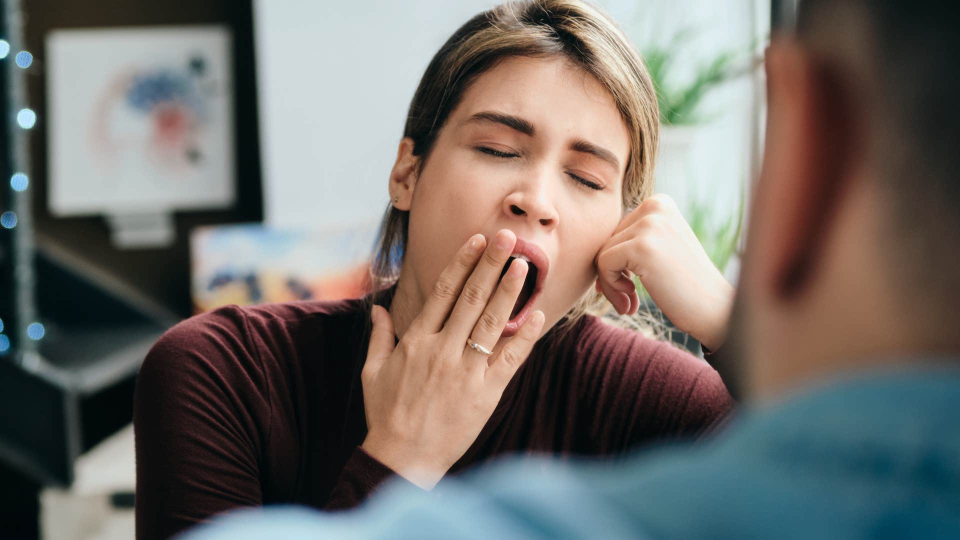 woman yawning saying whatever to a man