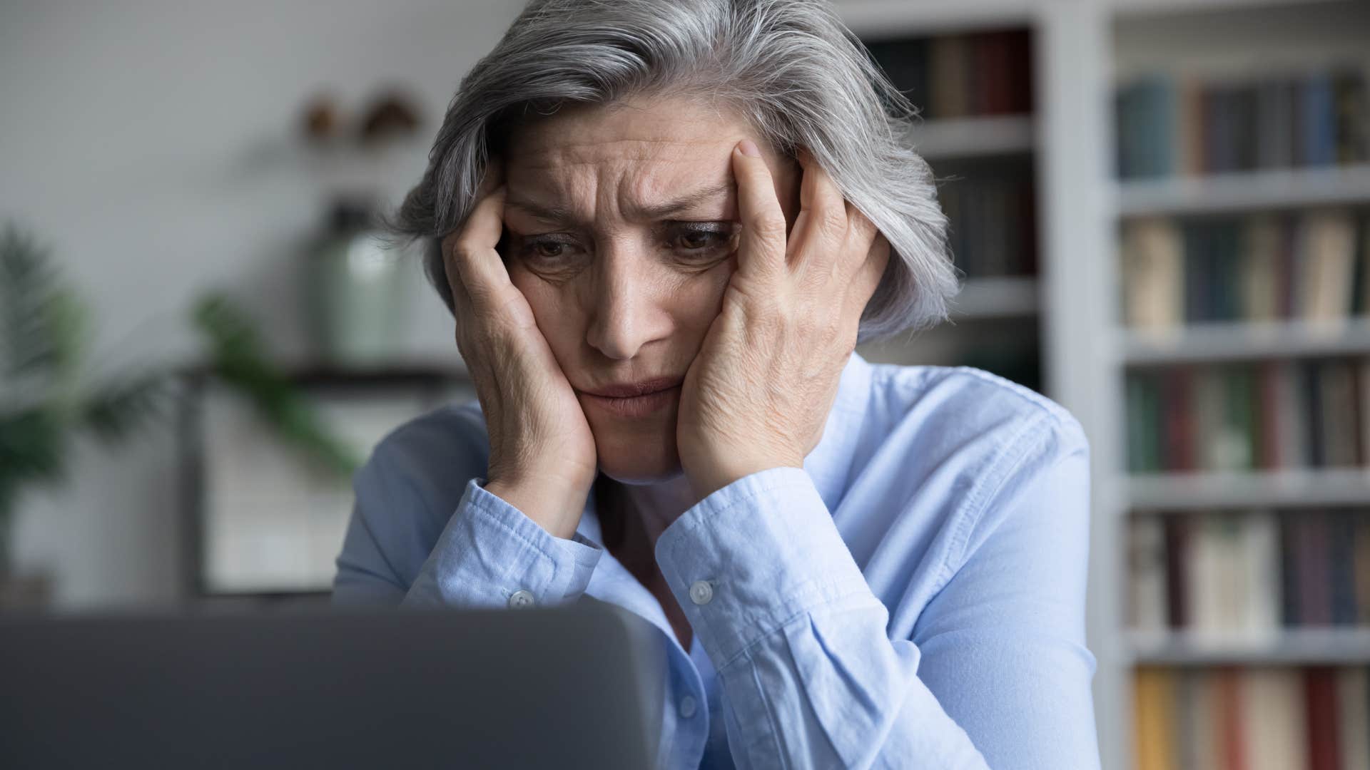 exhausted woman saying I'm just really tired on her computer