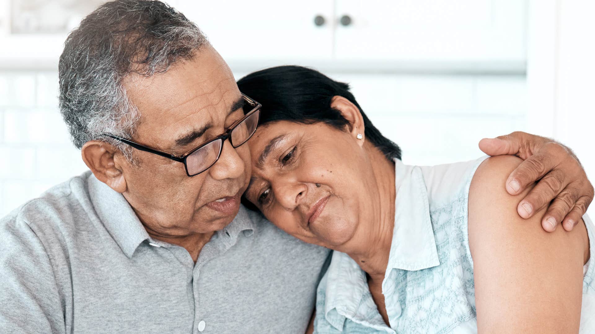 exhausted woman telling husband i just need a break leaning on him