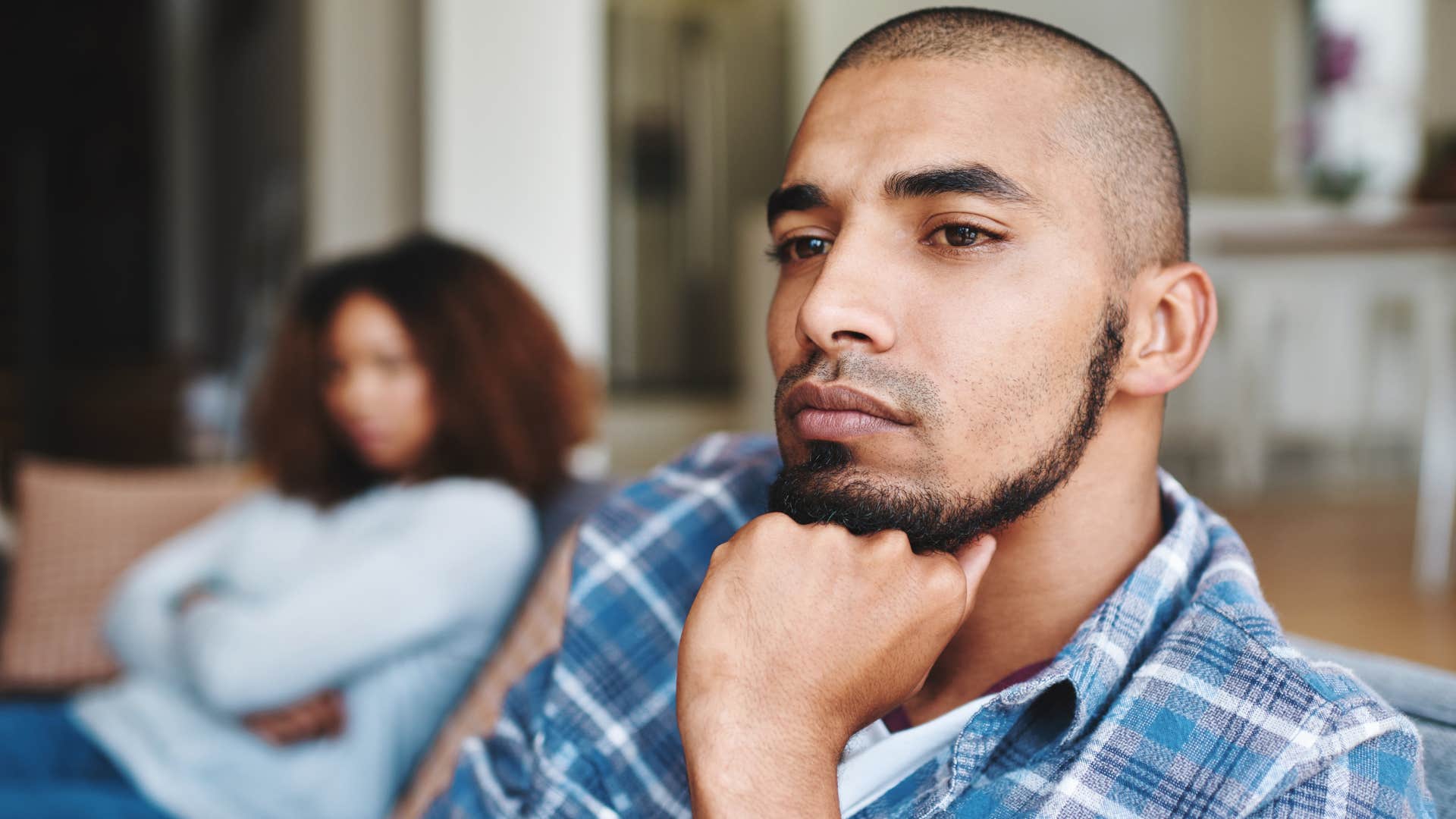 unhappy man saying sorry" to his wife turned away from her