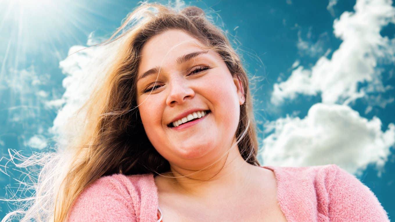 People Who Do These Things Are Happier With Their Bodies (And Their Lives) Woman who is happy with her body and life.