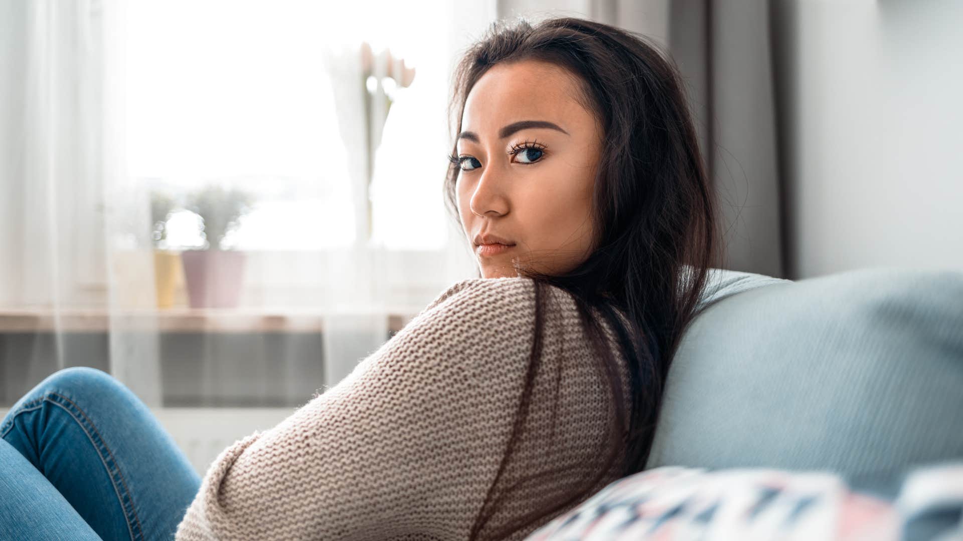woman with no friends sitting alone at home