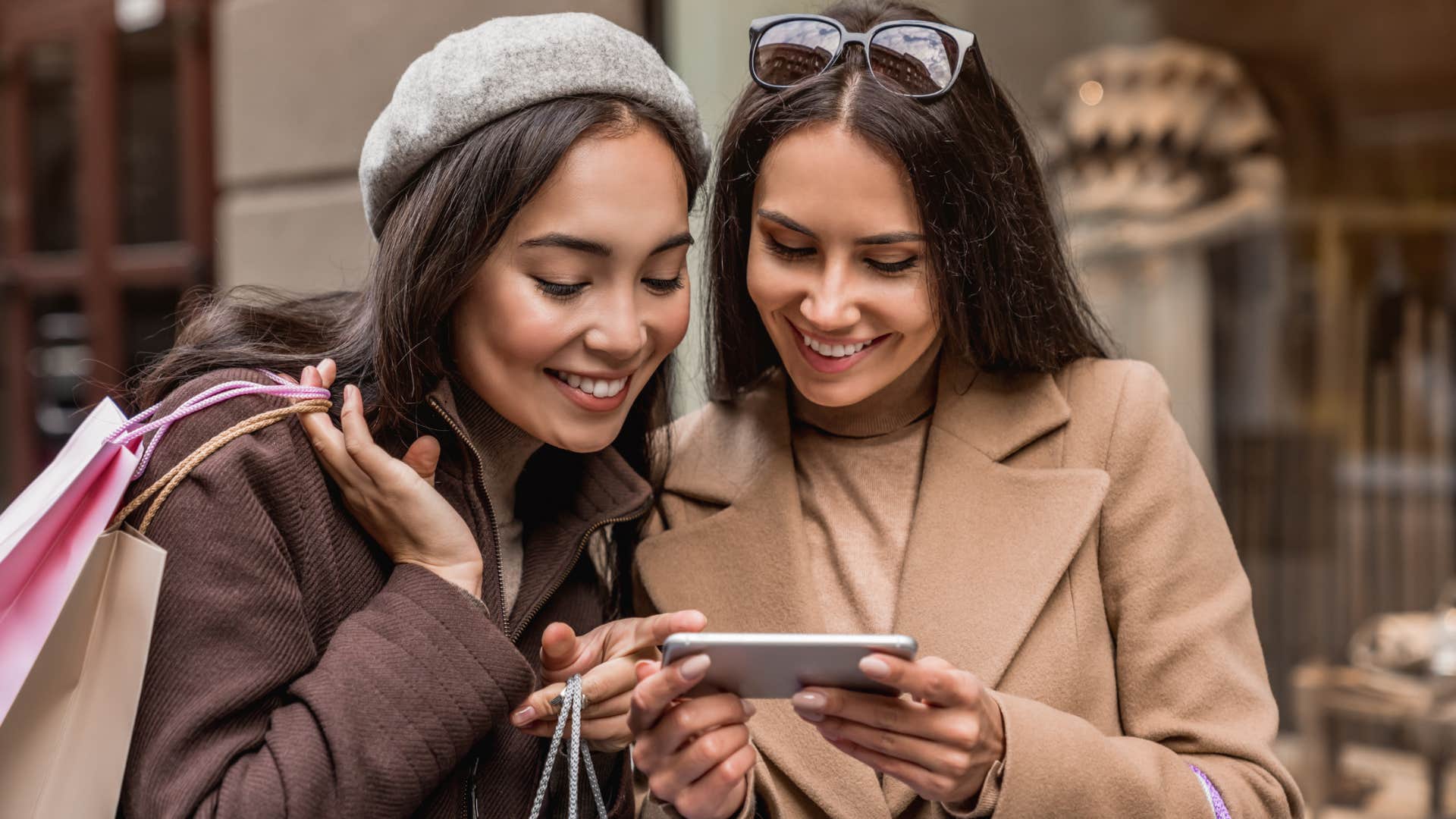 friends laughing looking at taylor swift fans on device